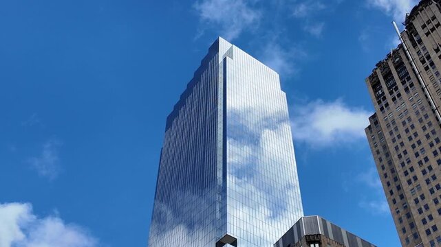 Architecture building business area. Glass skyscraper sky reflection. Sky reflection on business district city. Modern commercial architecture. Business skyscraper building. Low angle view