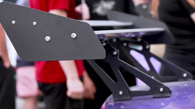 Large Carbon Fiber Rear Spoiler on Performance Sport Car, Aerodynamic Tuning Close-Up
