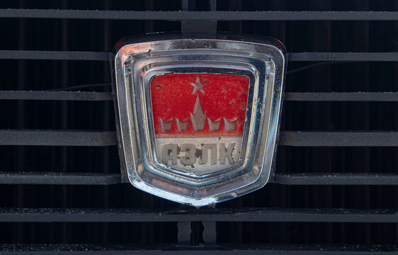 VORONEZH, Russia - April 25, 2026.Macro view of the red AZLK emblem badge on the black grille of a Moskvitch car