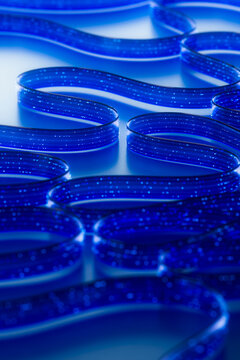 3D blue network field with repeating loops and light points.