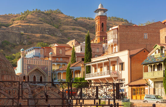 View of traditional balconies, colorful buildings and the historic district of Abanotubani with hillside architecture in Tbilisi, Georgia.
