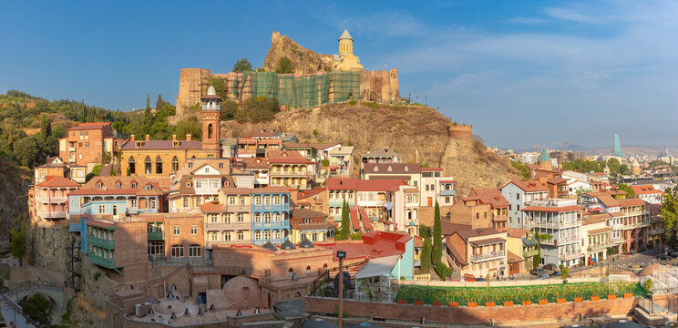 Panoramic view of Narikala Fortress overlooking the historic district with traditional houses and churches in Tbilisi, Georgia.