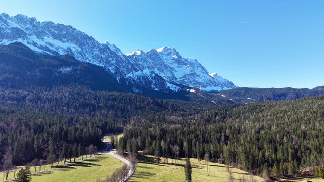Aerial View of Mountain Road Passing Through Forested Alpine Valley in Bavaria