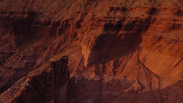 FPV Drone Flying Close Around Tall Sandstone Rock Tower in Desert