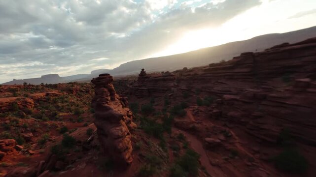 FPV Drone Flying Fast Through Red Rock Canyon During Golden Hour Sunset