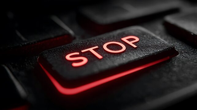 A high-resolution shot of a STOP key with a focus on its red hue