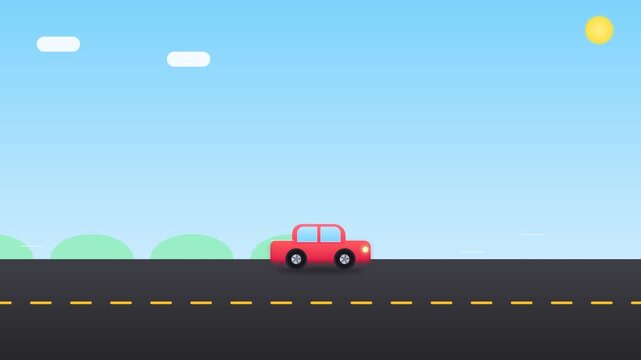 Red car driving on an asphalt road under a clear blue sky