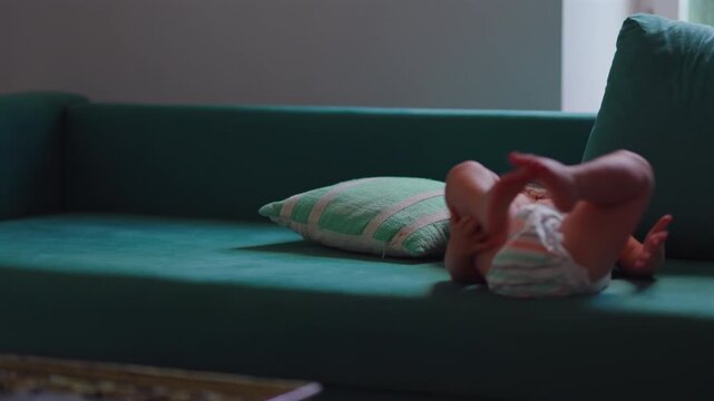 Toddler jumping into couch during active play at home, highlighting gross motor development, fearless exploration and joyful childhood adventure