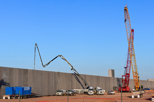 Large data center campus under construction with cranes, concrete pumps, and heavy equipment, illustrating AI, cloud computing, digital infrastructure, and hyperscale development