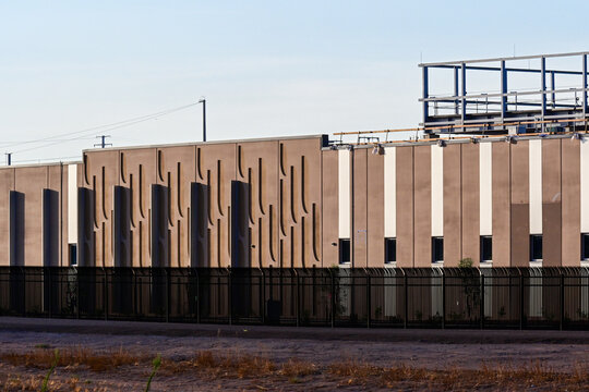 Partial exterior view of a data center building under construction at a large campus, illustrating AI infrastructure, cloud computing, digital expansion, and commercial development