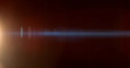Warm anamorphic lens flare overlay featuring a golden light source, blue horizontal light streak, realistic optical reflections and subtle glow on a black background. Premium VFX asset. © Jag_cz