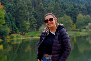 Fototapeta premium portrait of young beautiful woman near the lake in Autumn 