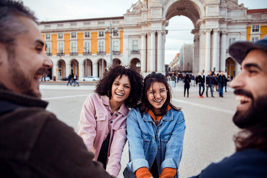 Friends laughing at pra?a do com?rcio in lisbon