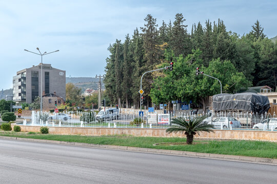 Scenic view of the main road in Alanya featuring decorative fountains and blue highway signs to Antalya. Modern infrastructure in the Dinek and Kizlar Pinari area. Alanya, Turkey - October 25, 2020