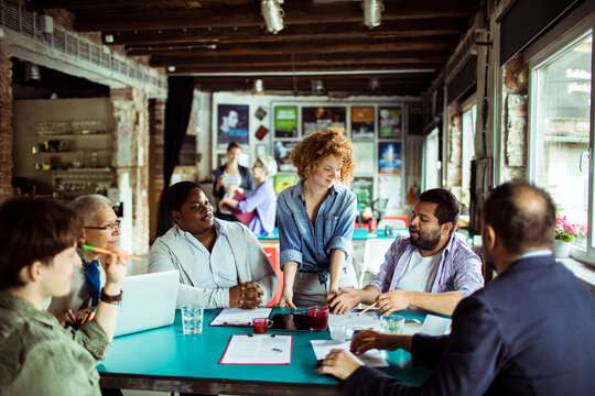 Diverse coworkers brainstorming in a creative coworking loft office