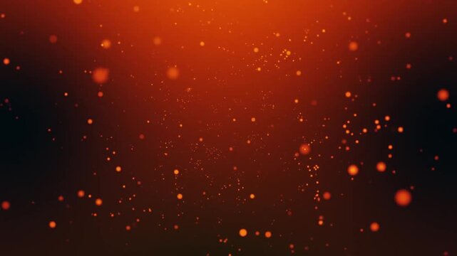 Abstract glowing orange and red dust particles floating in dark background