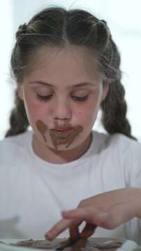Child with chocolate on face, delightful dirty eating. Messy face child enjoys chocolate, dirty joy. Kid relishes chocolate, dirty face. Child face dirty with chocolate, joyful eating. Delightful kld