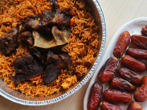 Saudi Arabia_Two servings of lamb kabsah rice bought online and dates