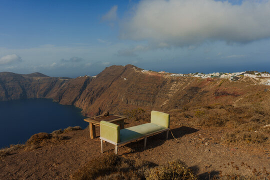 Couch and coffee table on the cliffside overlooking the sea 