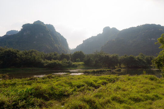 Grass field and calm river in Ninh Binh, Vietnam 