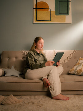 Woman using tablet computer at home 