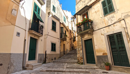 Fototapeta premium Narrow European Alleyway with Stone Steps and Balconies.