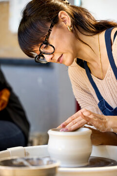 Crafting Clay Pot in Artisan Workshop Setting