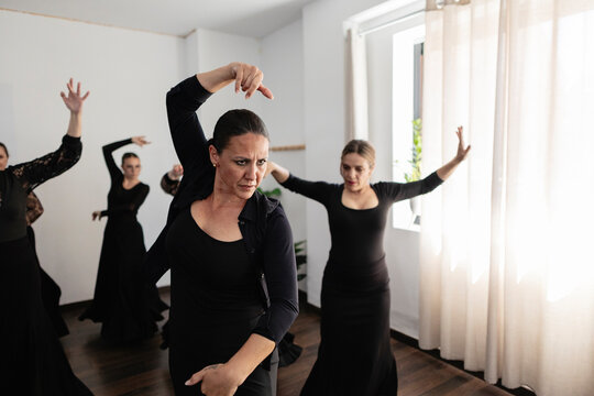 Women performing traditional flamenco dance during practice