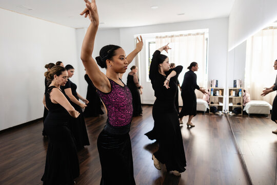 Women dancing flamenco during a group class in a studio