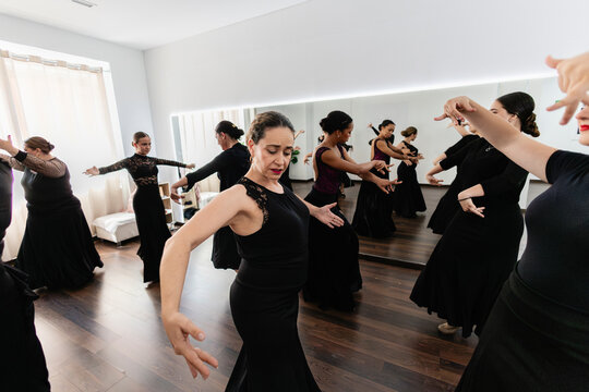 Women practicing flamenco dance in a studio class