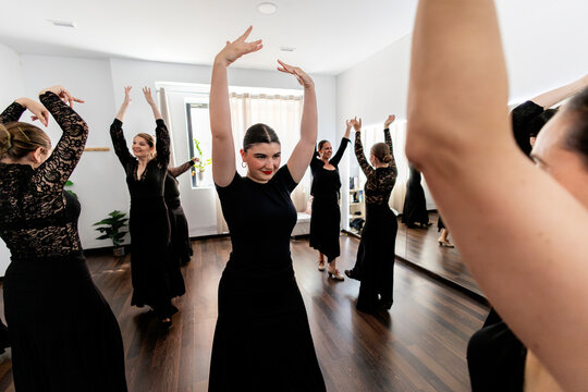 Women learning traditional flamenco dance in studio