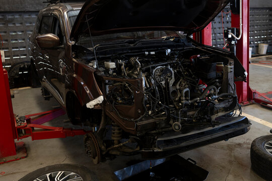 Disassembled Vehicle Undergoing Major Automotive Repair in Workshop