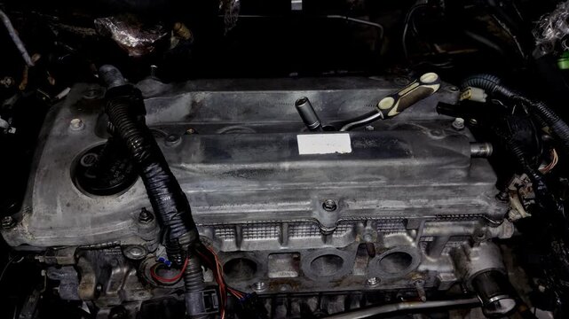 Top view of an open car engine bay with the intake manifold removed.