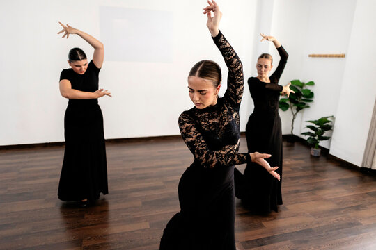 Female dancers practicing traditional spanish flamenco dance