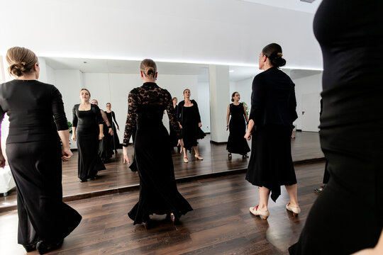 Women learning flamenco dance in a studio