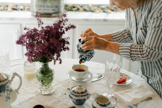 hands of woman serving  tea 