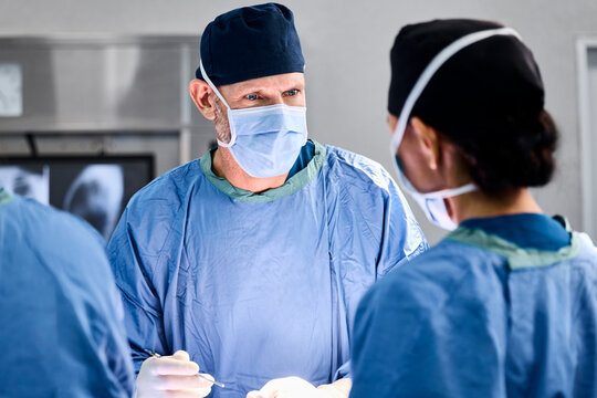 Surgeons Collaborate in a Surgical Procedure