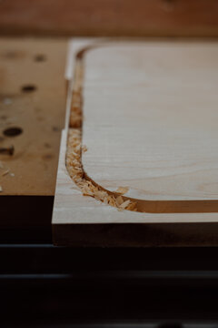 Woodworking router cut with wood shavings on workbench