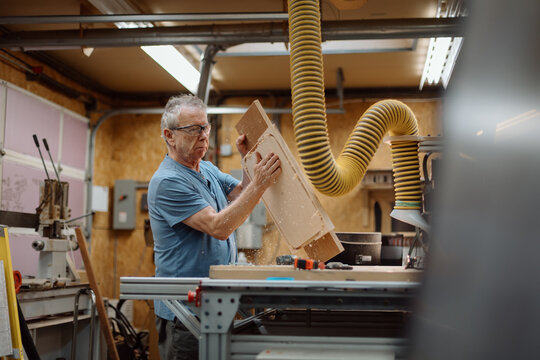 Senior craftsman working in a woodworking shop