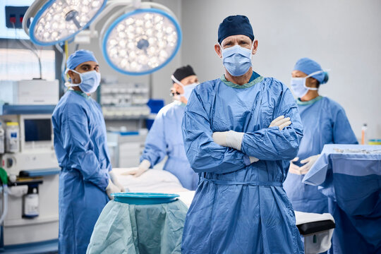 Surgeon stands confidently in operating room with team a