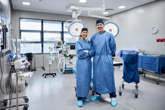 Two smiling surgeons pose together