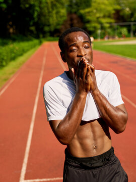 Runner Takes a Break and Catches Breath After Training Session