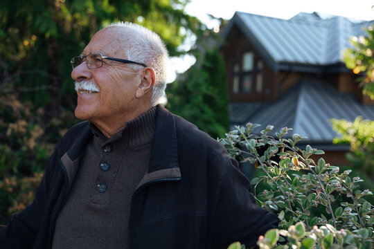 Candid portrait of a happy senior man enjoying his garden
