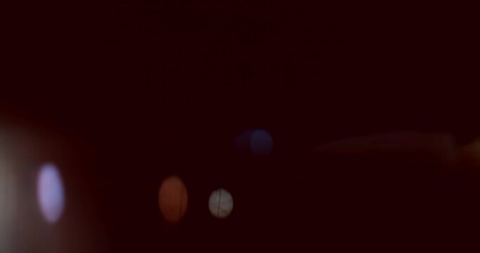 Cinematic moving lens flare overlay in super slow motion featuring glow, soft optical reflections and realistic lens artifacts on a black background. Premium VFX element for compositing.