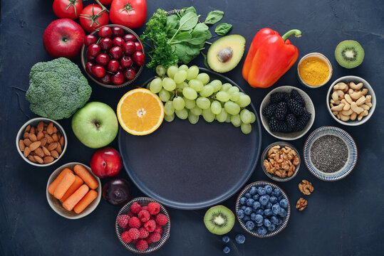 Healthy antioxidant rich foods flat lay on dark background with copy space