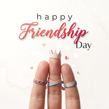 Celebrating friendship day with crowned fingers and colorful bands against soft background with blurred backdrop floating decorative hearts festive text