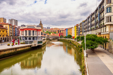 Obraz premium Downtown District of Bilbao, Spanish Basque Country, Spain with Nervion River on overcast summer day