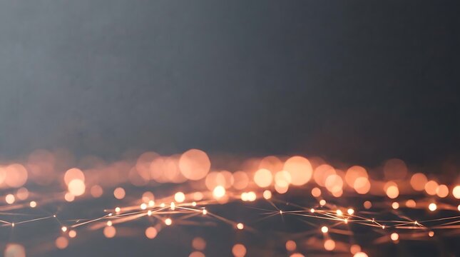 Golden glowing bokeh particles over dark horizontal plane