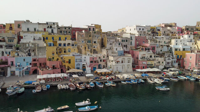 Beautiful sunset view of Procida old town above Mediterranean waters.
