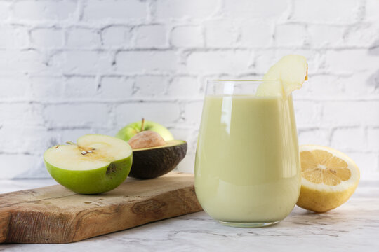 Healthy green smoothie with apple avocado and lemon
